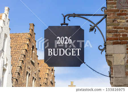 2026 Budget symbol. Concept words 2026 Budget on beautiful black road sign. Beautiful street and buildings in Brugge blue sky background. Business and 2026 budget concept. Copy space. 133816975