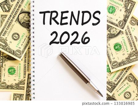 Trends 2026 new year symbol. Concept words Trends 2026 on beautiful white note. Beautiful dollar bills background. Black pen. Dollar bills. Business and Trends 2026 new year concept. Copy space. 133816985