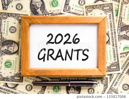 2026 Grants symbol. Concept words 2026 Grants on beautiful wooden picture frame. Beautiful dollar bills background. Black pen. Dollar bills. Business and 2026 grants concept. Copy space. 2026 Grants symbol. Concept words 2026 Grants on beautiful wooden picture frame. Beautiful dollar bills background. Black pen. Dollar bills. Business and 2026 grants concept. Copy space. 133817006