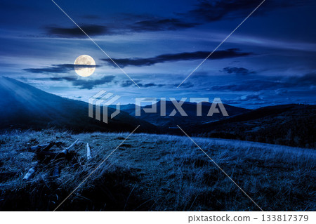 beautiful countryside at night. wonderful summertime landscape in mountains in full moon light. scenic view of grassy field and rolling hills. background for rural land investment or abstract concepts beautiful countryside at night. wonderful summertime landscape in mountains in full moon light. scenic view of grassy field and rolling hills. background for rural land investment or abstract concepts 133817379