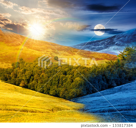 beech forest on the hill on summer solstice. day and night time change concept. mountains under blue sky with sun and moon at twilight. beautiful background for duality and transition template 133817384