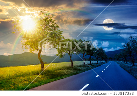 trees along the country road in to mountains. day and night time change concept. beautiful summer landscape with with sun and moon on epic sky. motion blur effect. harmony and progress calendar trees along the country road in to mountains. day and night time change concept. beautiful summer landscape with with sun and moon on epic sky. motion blur effect. harmony and progress calendar 133817388