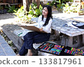 Asian Girl Drawing Outdoors with Colorful Art Supplies in Creative Learning Activity 133817961