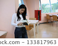 Asian Student Reading Book Indoors in Library Learning Area 133817963
