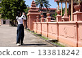 Asian Woman Taking Photos of Traditional Temple Architecture Outdoors 133818242