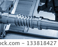 The  CNC lathe machine groove cutting the metal ball screw shaft parts in the light blue scene. 133818427