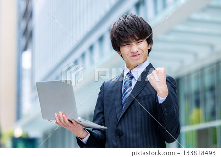 Businessman with laptop in office Businessman with laptop in office 133818493