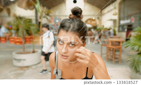 A woman enjoying her time in an urban cafe that features a beautiful natural aesthetic A woman enjoying her time in an urban cafe that features a beautiful natural aesthetic 133818527