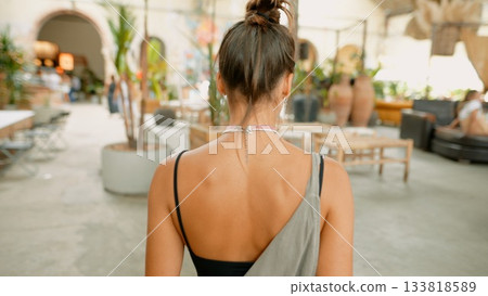 A Stylish Woman Seated in a Contemporary Lounge Setting That Exudes Comfort and Elegance 133818589