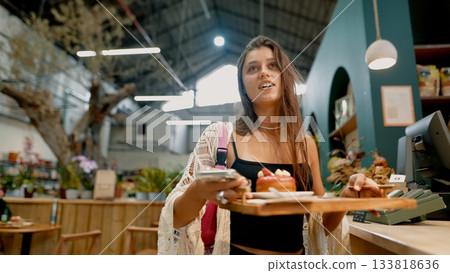 Young Woman Enjoying Desserts in a Cozy Caf Setting Young Woman Enjoying Desserts in a Cozy Caf Setting 133818636