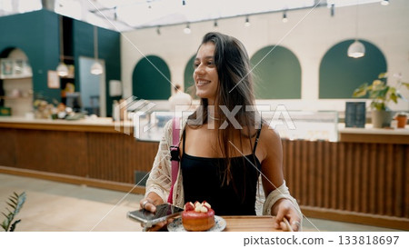 Joyful Woman Enjoying Dessert in Trendy Caf 133818697
