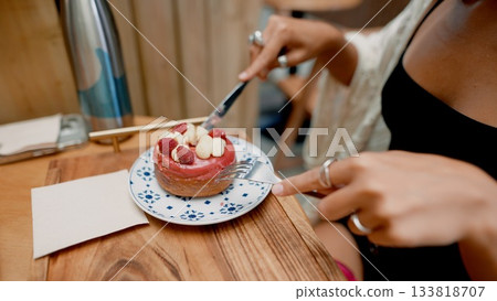 Indulge in a delicious cake while enjoying the cozy atmosphere of a charming cafe Indulge in a delicious cake while enjoying the cozy atmosphere of a charming cafe 133818707