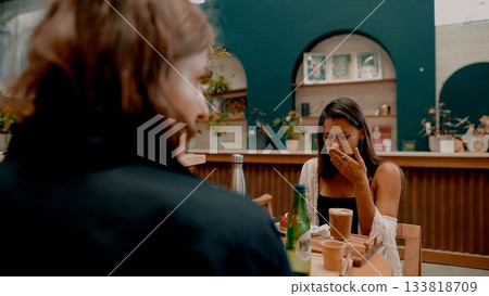 A Candid Moment Captured at a Cozy Cafe The Joy of Laughter and Connection with Friends 133818709