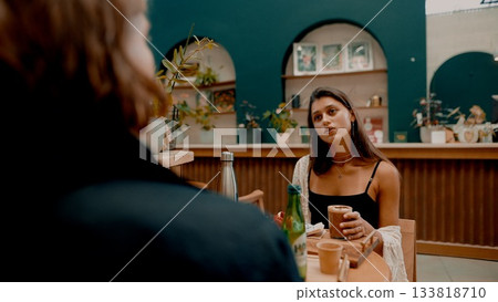 A relaxed and enjoyable cafe conversation occurring between a group of close friends A relaxed and enjoyable cafe conversation occurring between a group of close friends 133818710