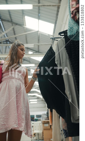 A Fashionista Enjoying Shopping for Trendy Clothes in an Elegant and Modern Boutique Store 133818802