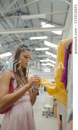 A Fashion Enthusiast Enjoys Exploring a Colorful and Diverse Clothing Rack Full of Styles A Fashion Enthusiast Enjoys Exploring a Colorful and Diverse Clothing Rack Full of Styles 133818841