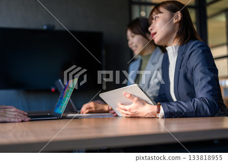 Business woman with tablet and laptop in conference room 133818955