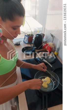 Cooking in a Bright and Cheerful Kitchen Preparing Delicious Eggs for Breakfast Meals 133819151