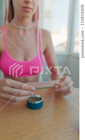 A Young Woman is Joyfully Preparing for a Creative Artistic Session in a Bright, Airy Space 133819309