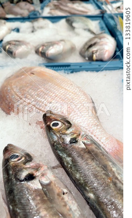 Explore the exquisite and fresh seafood display that is showcased at the local fish market Explore the exquisite and fresh seafood display that is showcased at the local fish market 133819605