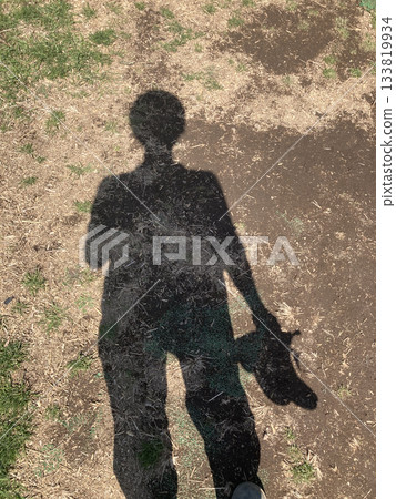 Human silhouette and soil texture during farm work 133819934