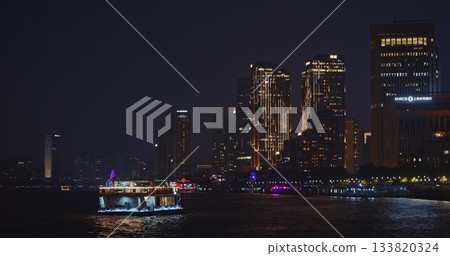 Scenic Night View of Riverboat Illuminated by Cityscape in Shanghai Area 133820324