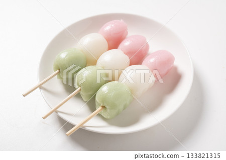 Three-colored dumplings on a white plate 133821315