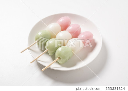 Three-colored dumplings on a white plate 133821824