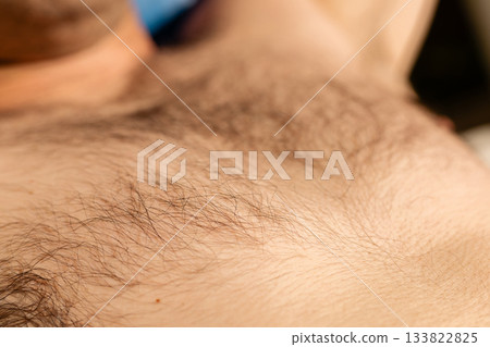 This scene focuses on the close-up of body hair, showcasing the natural texture. It reflects personal grooming practices and the emphasis on smooth skin This scene focuses on the close-up of body hair, showcasing the natural texture. It reflects personal grooming practices and the emphasis on smooth skin 133822825