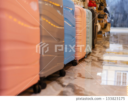 Luggage in various pastel colors is neatly arranged in a retail setting, appealing to travelers seeking stylish and practical options Luggage in various pastel colors is neatly arranged in a retail setting, appealing to travelers seeking stylish and practical options 133823175