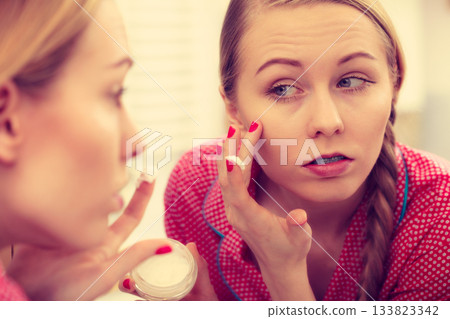 Woman applying moisturizing skin cream. Skincare. Woman applying moisturizing skin cream. Skincare. 133823342