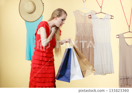 Woman in shop picking clothes, sale concept Woman in shop picking clothes, sale concept 133823360