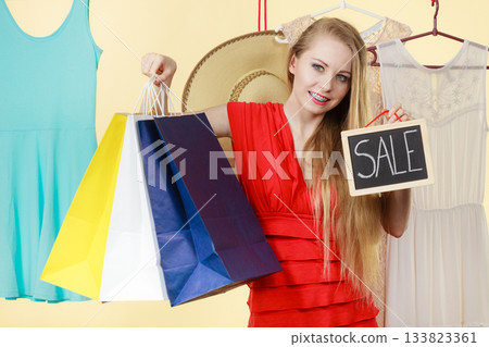 Woman in shop picking clothes, sale concept Woman in shop picking clothes, sale concept 133823361