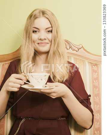 Woman drinking hot coffee beverage. Caffeine. Woman drinking hot coffee beverage. Caffeine. 133823369