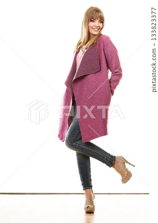 blonde fashionable woman in vivid color coat. blonde fashionable woman in vivid color coat. 133823377