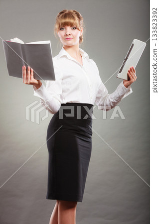 Woman learning with ebook and book. Education. Woman learning with ebook and book. Education. 133823392