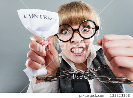 Furious woman with chained hands and contract 133823398