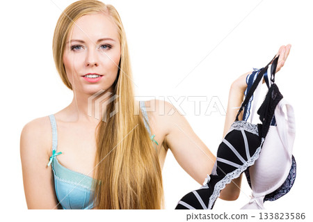 Woman choosing bra to wear Woman choosing bra to wear 133823586