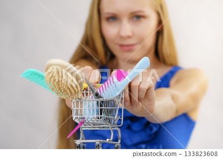 Girl with hair accessories in shopping cart Girl with hair accessories in shopping cart 133823608