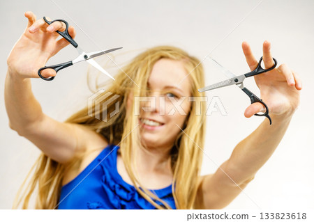 Girl with scissors for haircutting Girl with scissors for haircutting 133823618