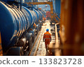An oil refinery. worker walks along tanks 133823728