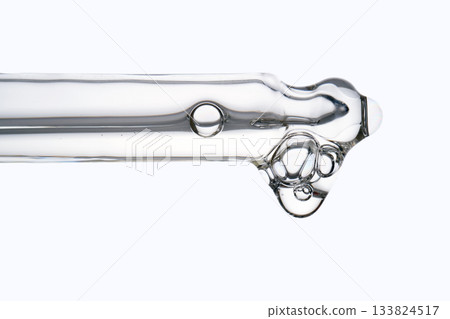 Cosmetic pipette dispensing serum with liquid drop and bubbles 133824517