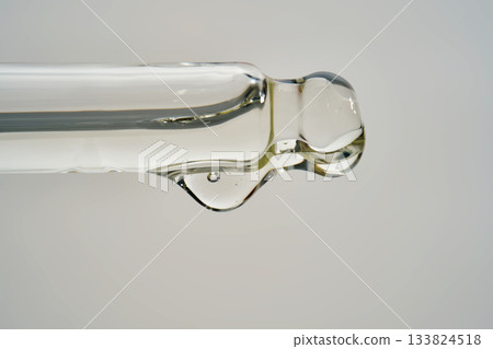 Cosmetic pipette dispensing serum drop for skincare routine Cosmetic pipette dispensing serum drop for skincare routine 133824518