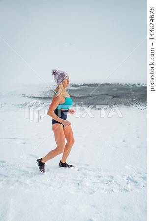 Elderly winter swimmer warming up before cold plunge in lake. 133824678