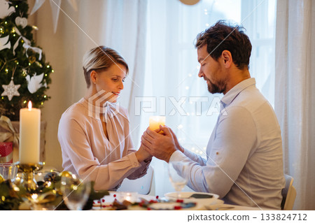 Christmas romance for couple, holding cande. 133824712