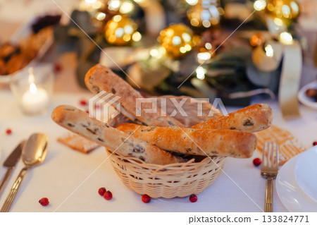 Breadsticks at christmas table. Christmas dinner at home. Breadsticks at christmas table. Christmas dinner at home. 133824771