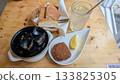 Steamed mussels, croquette, limeade on the table 133825305
