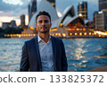 Confident and poised, a young Aboriginal business innovator stands outdoors with the iconic Sydney Opera House behind him. A modern leader blending heritage and ambition in a powerful urban setting. 133825372