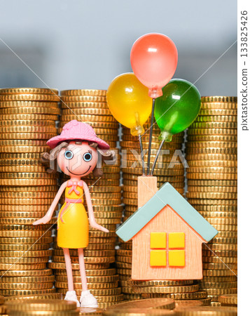 Toy girl and house with colorful balloons standing on stacks of gold coins symbolizing saving goals Toy girl and house with colorful balloons standing on stacks of gold coins symbolizing saving goals 133825426