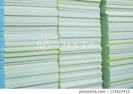 Stacked insulation foam boards at construction site ready for building thermal insulation work Stacked insulation foam boards at construction site ready for building thermal insulation work 133825452